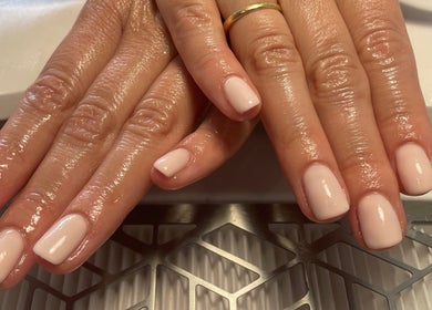 Freshly manicured hands with glossy nails at No10 Beauty & Aesthetics in Woodbridge, England, GB.