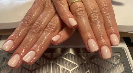 Freshly manicured hands with glossy nails at No10 Beauty & Aesthetics in Woodbridge, England, GB.
