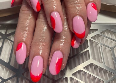 Bright pink and red nail art at No10 Beauty & Aesthetics in Woodbridge, England, GB.