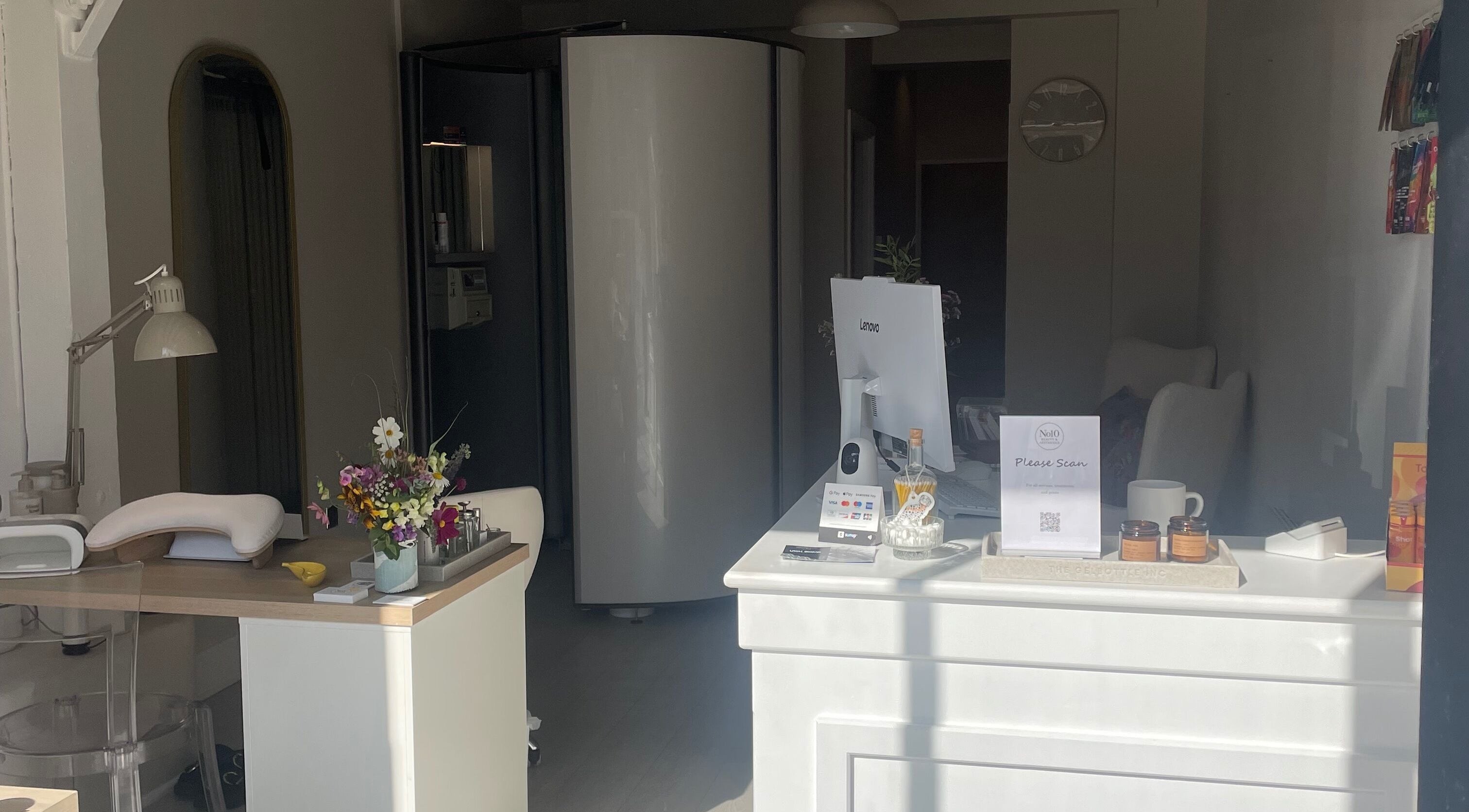Reception area at No10 Beauty & Aesthetics in Woodbridge, England showcasing treatment and welcome desk.