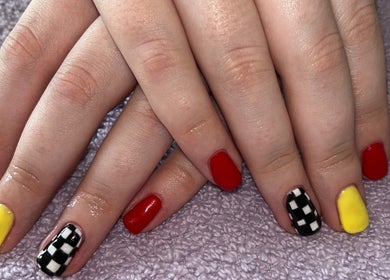 Colorful nail art featuring red, yellow, and checkered designs at Polished by Molly, Hedge End, England, GB.
