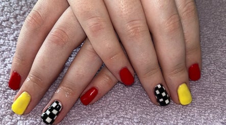 Colorful nail art featuring red, yellow, and checkered designs at Polished by Molly, Hedge End, England, GB.