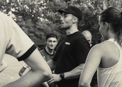Group fitness training at Jnemzcoaching, Wellington, England, GB, with a coach motivating participants outdoors.