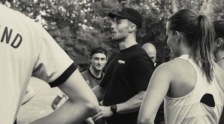 Group fitness training at Jnemzcoaching, Wellington, England, GB, with a coach motivating participants outdoors.