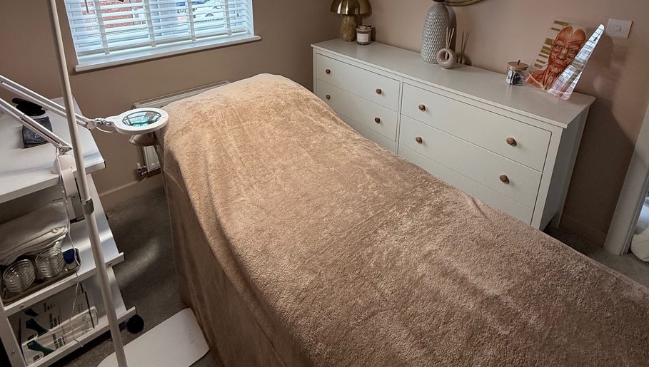 Relaxing treatment room at Chloe Zeller Skin in Tockwith, England, GB, featuring a cozy massage bed and warm decor.