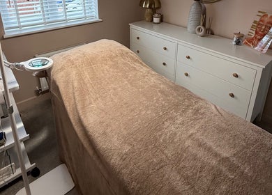 Relaxing treatment room at Chloe Zeller Skin in Tockwith, England, GB, featuring a cozy massage bed and warm decor.