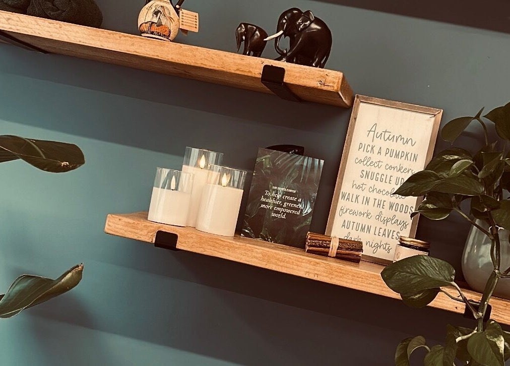 Warm wooden shelves with decor and plants at Serene Glow by Charlotte Aimée, Bristol, England, GB