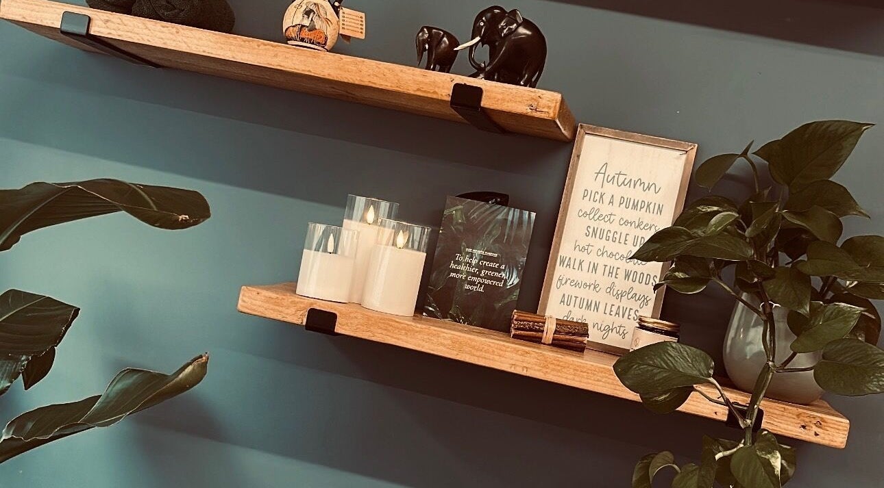 Warm wooden shelves with decor and plants at Serene Glow by Charlotte Aimée, Bristol, England, GB