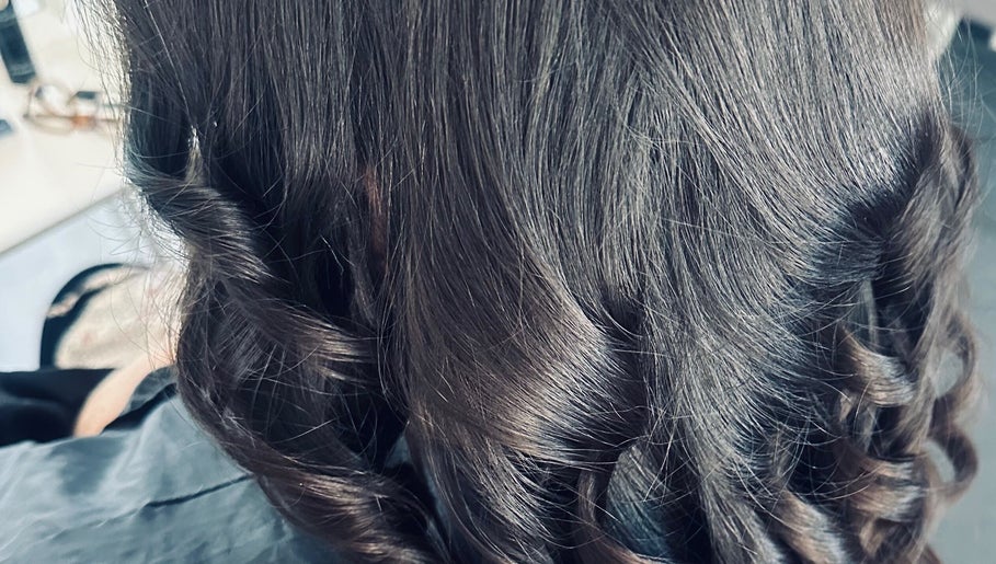 Elegant curled hair styled at Hair By Amina, London, England, GB.