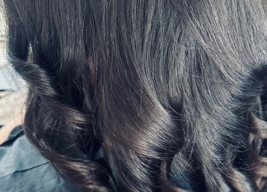 Elegant curled hair styled at Hair By Amina, London, England, GB.