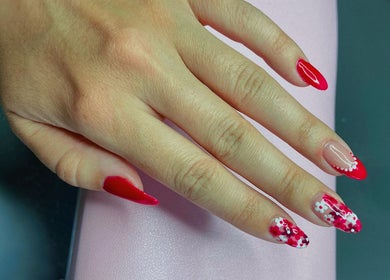 Stylish red floral nail art at Nails by Megan Caroline, Ballymena, Northern Ireland, GB.
