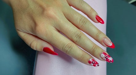 Stylish red floral nail art at Nails by Megan Caroline, Ballymena, Northern Ireland, GB.
