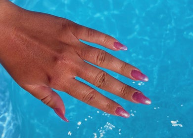 Glittery pink nails by Nails by Megan Caroline, Ballymena, Northern Ireland, GB, over a sparkling blue pool.