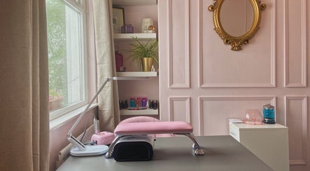 Nail station at Nails by Megan Caroline, Ballymena, Northern Ireland. Features pink decor and manicuring tools.