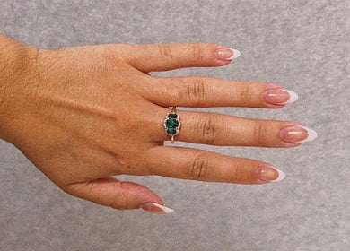 Elegant French manicure at Nails by Megan Caroline, Ballymena, Northern Ireland, GB, showcasing a green gemstone ring.