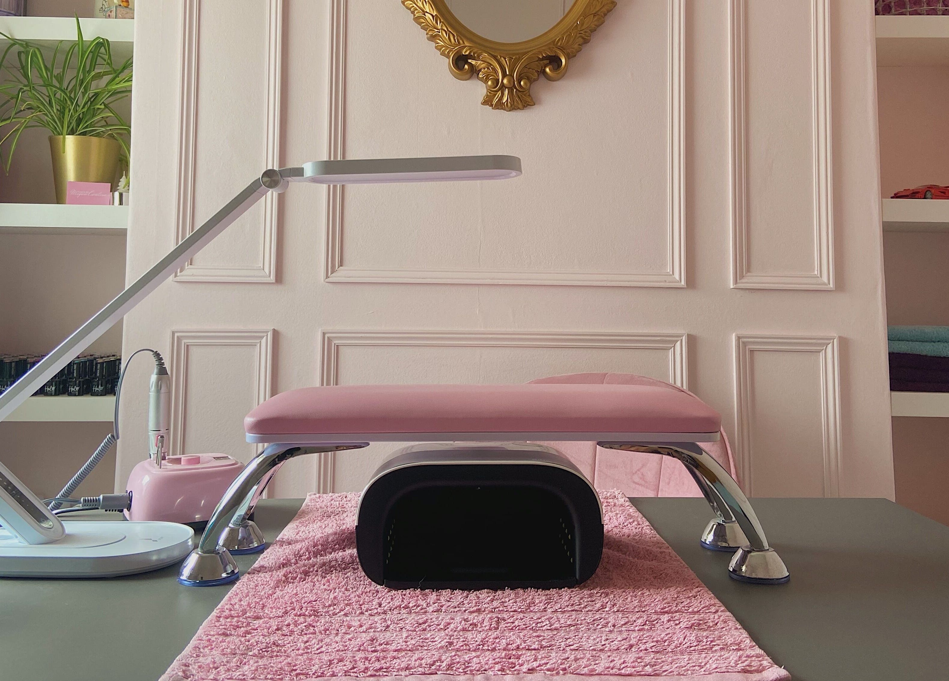 Elegant manicure setup at Nails by Megan Caroline, Ballymena, Northern Ireland, GB, with pink and gold decor.