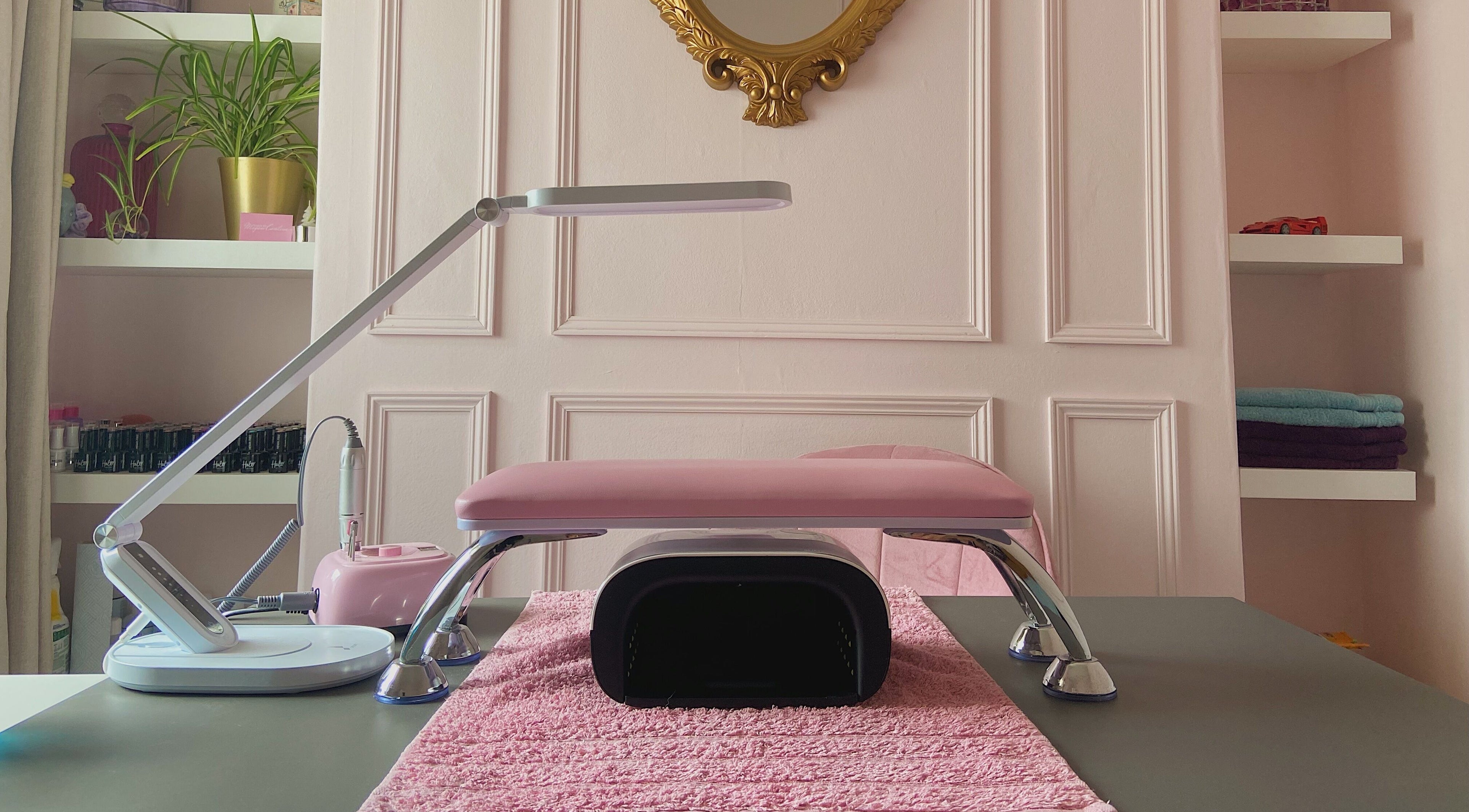 Elegant manicure setup at Nails by Megan Caroline, Ballymena, Northern Ireland, GB, with pink and gold decor.
