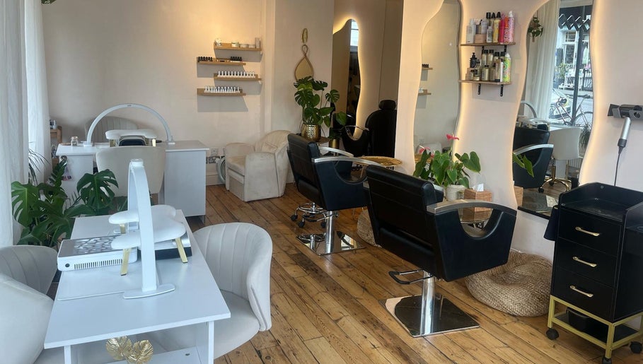 Modern interior of Joshua Levi Hair in London, England, GB with stylish chairs and wooden flooring.