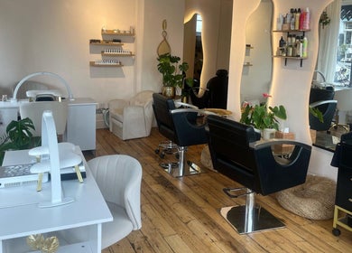 Modern interior of Joshua Levi Hair in London, England, GB with stylish chairs and wooden flooring.