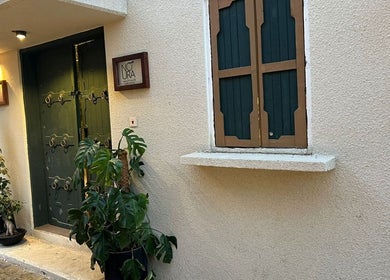 Inviting entrance of Glowin Salon, Abha, Al Athar 7507, SA, showcasing stylish decor and lush greenery.