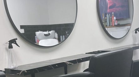 Modern salon station with round mirrors at Elite Hair Salon, Chester, England, GB.