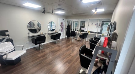 Sleek interior of Elite Hair Salon, Chester, England, GB showcasing modern design and comfortable styling chairs.