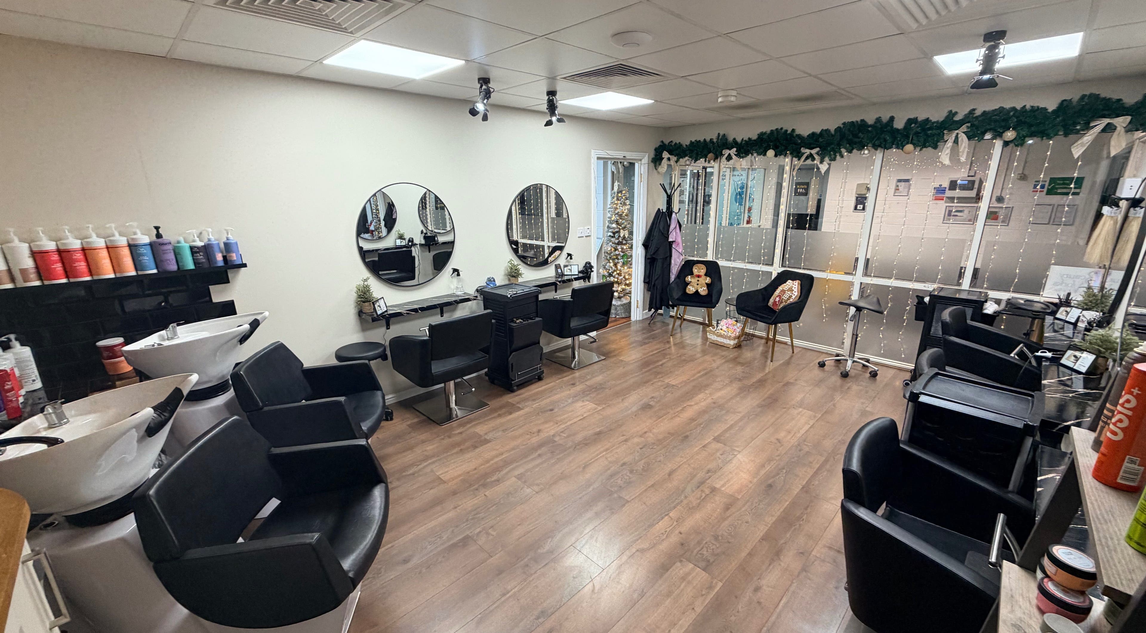 Modern salon interior at Elite Hair Salon in Chester, England, GB with stylish chairs and decor.