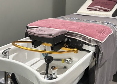 A luxury spa setup at Blissful Bay Inc., Schaumburg, Illinois, US featuring a massage table and basin.