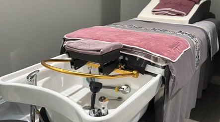 A luxury spa setup at Blissful Bay Inc., Schaumburg, Illinois, US featuring a massage table and basin.