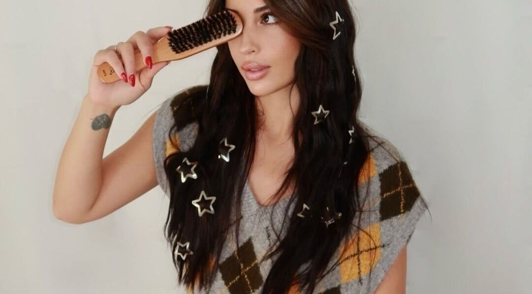 Woman with star hair accessories using brush at Silk Tech Hair, NORTH MIAMI, Florida, US.