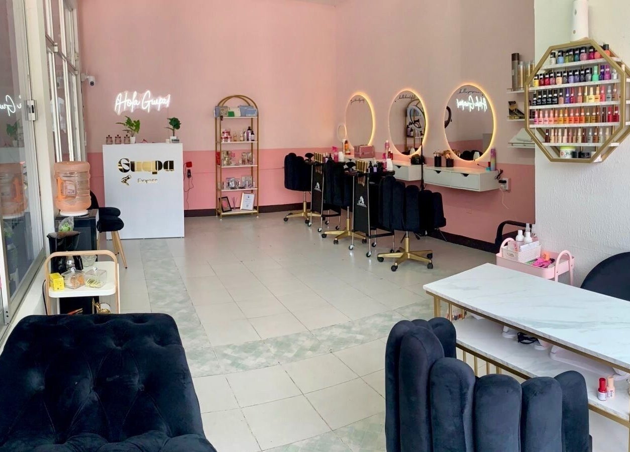 Interiores elegantes de Guapa Express en Irapuato, Guanajuato, MX, con estaciones de belleza y decoración moderna.
