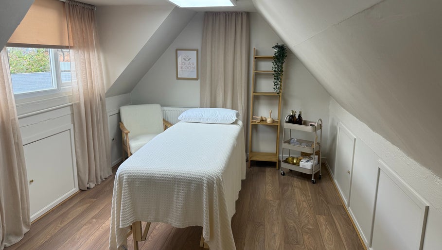Tranquil massage room at Lola & Bloom, Stanstead Abbotts, England, featuring a comfy massage bed and calming decor.