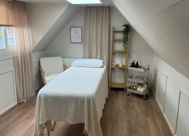 Tranquil massage room at Lola & Bloom, Stanstead Abbotts, England, featuring a comfy massage bed and calming decor.
