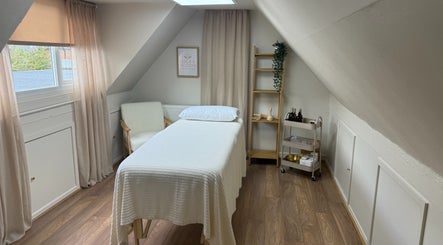 Tranquil massage room at Lola & Bloom, Stanstead Abbotts, England, featuring a comfy massage bed and calming decor.