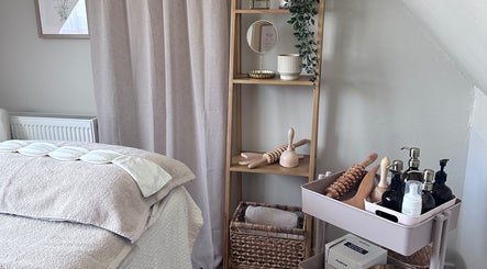 Tranquil therapy room at Lola & Bloom, Stanstead Abbotts, England, GB, showcasing massage tools and calming decor.