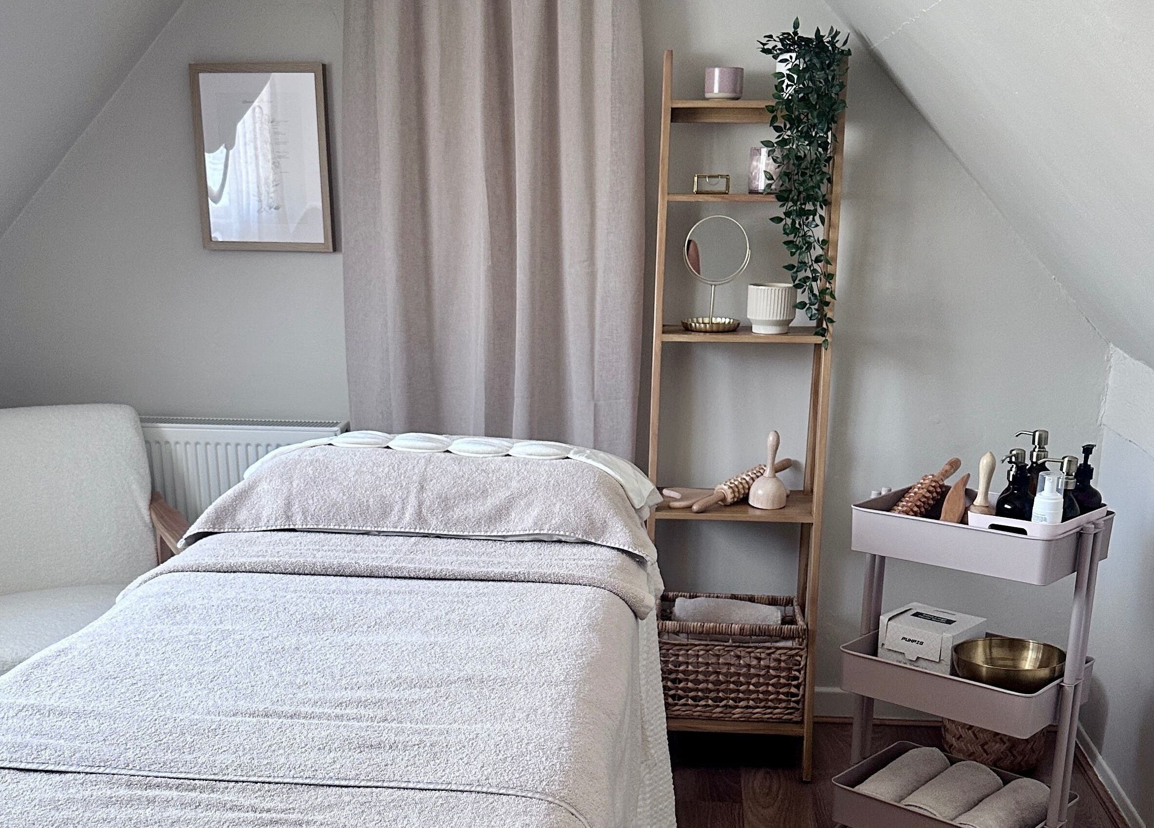 Serene treatment room at Lola & Bloom in Stanstead Abbotts, England, GB, featuring cozy massage table.