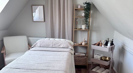 Serene treatment room at Lola & Bloom in Stanstead Abbotts, England, GB, featuring cozy massage table.