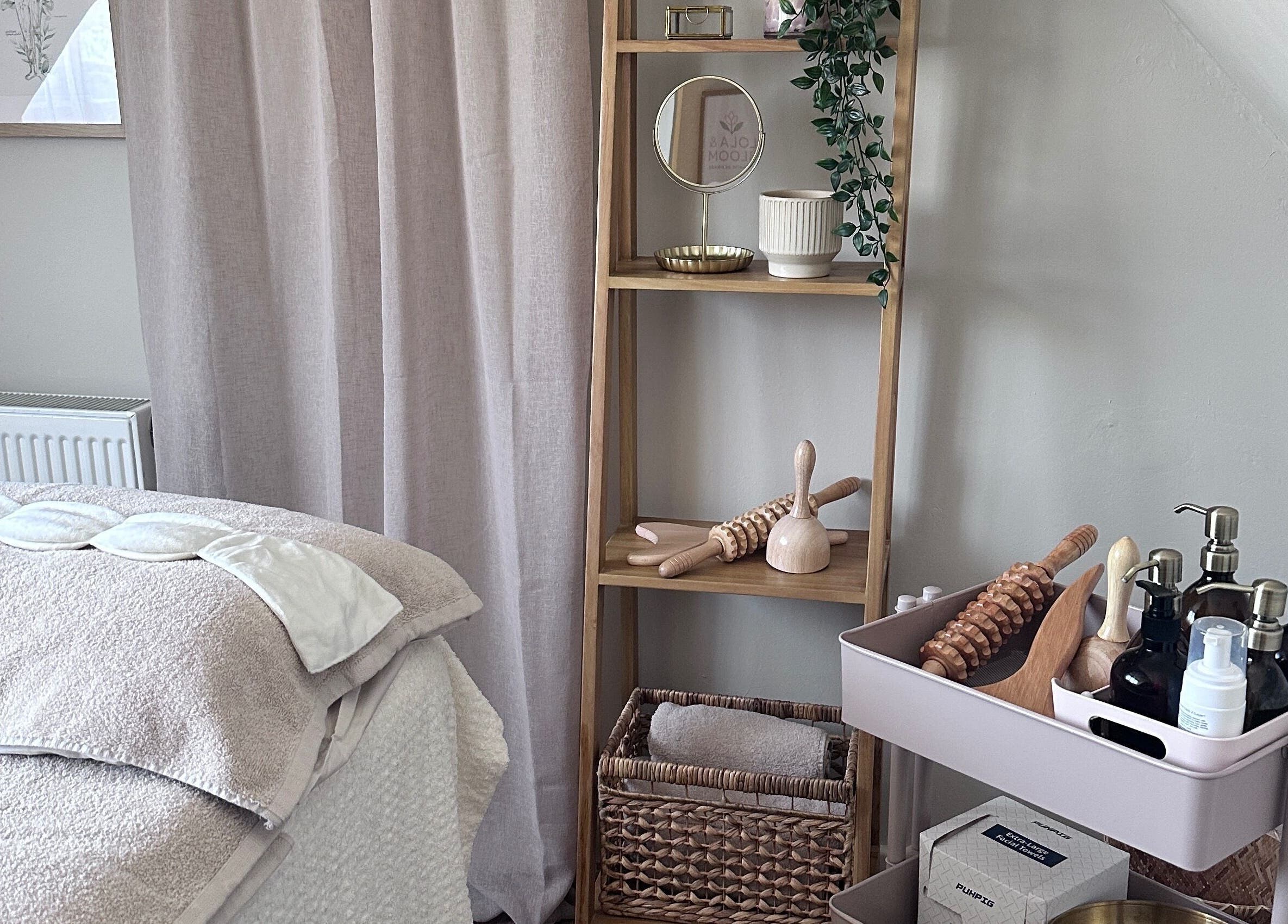 Cozy treatment room at Lola & Bloom in Stanstead Abbotts, England, GB, featuring calming decor and wellness tools.