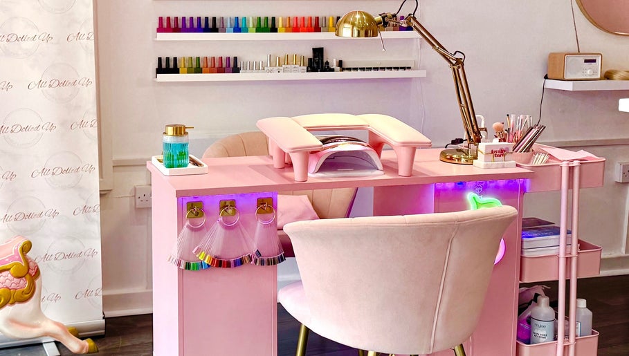Chic pink nail station at Yummy Gels in North Shields, England, GB. Vibrant polish display on the wall.