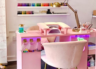 Chic pink nail station at Yummy Gels in North Shields, England, GB. Vibrant polish display on the wall.