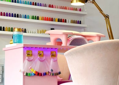 Nail salon station at Yummy Gels in North Shields, England showcasing colorful nail polish and modern decor.