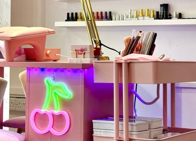 Pink manicure station with neon cherry light at Yummy Gels, North Shields, England, GB.