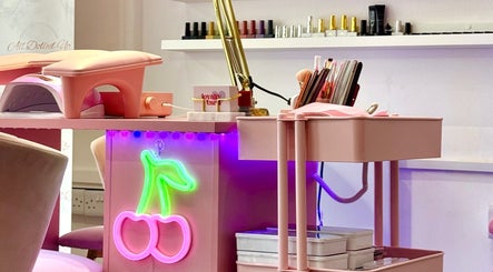 Pink manicure station with neon cherry light at Yummy Gels, North Shields, England, GB.