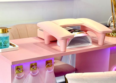 Modern nail station at Yummy Gels, North Shields, England, GB. Features pink decor and manicure equipment.