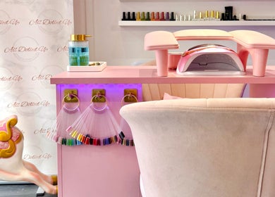 Chic nail salon setup at Yummy Gels, North Shields, England, GB, featuring pink decor and nail polish display.