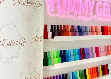 Colorful nail polish display at Yummy Gels, North Shields, England, GB with neon sign.