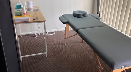 Massage table setup at Bare & Defined, Aberglasslyn, New South Wales, AU for relaxation and wellness.