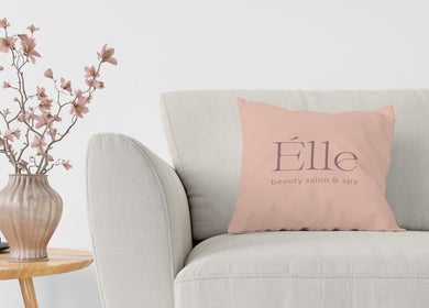 Elegant lounge at Elle Beauty Salon & Spa in Sharjah with stylish decor and cozy pillow.