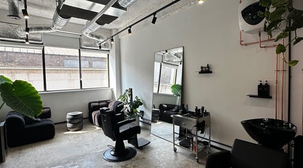 Chic interior of Cammarata Studio, London, England, GB with sleek salon chair and large window.