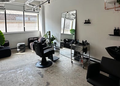 Modern salon setup at Cammarata Studio in London, England, GB with stylish seating and decor.